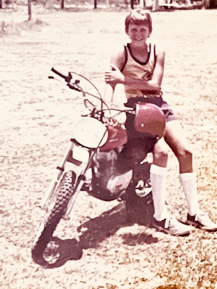 Young Scott van Iperen seated on a motorcycle